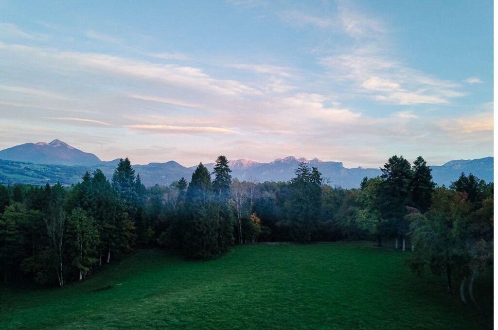 Grand Geneva estate parkland and woodland with Alpine backdrop at dusk